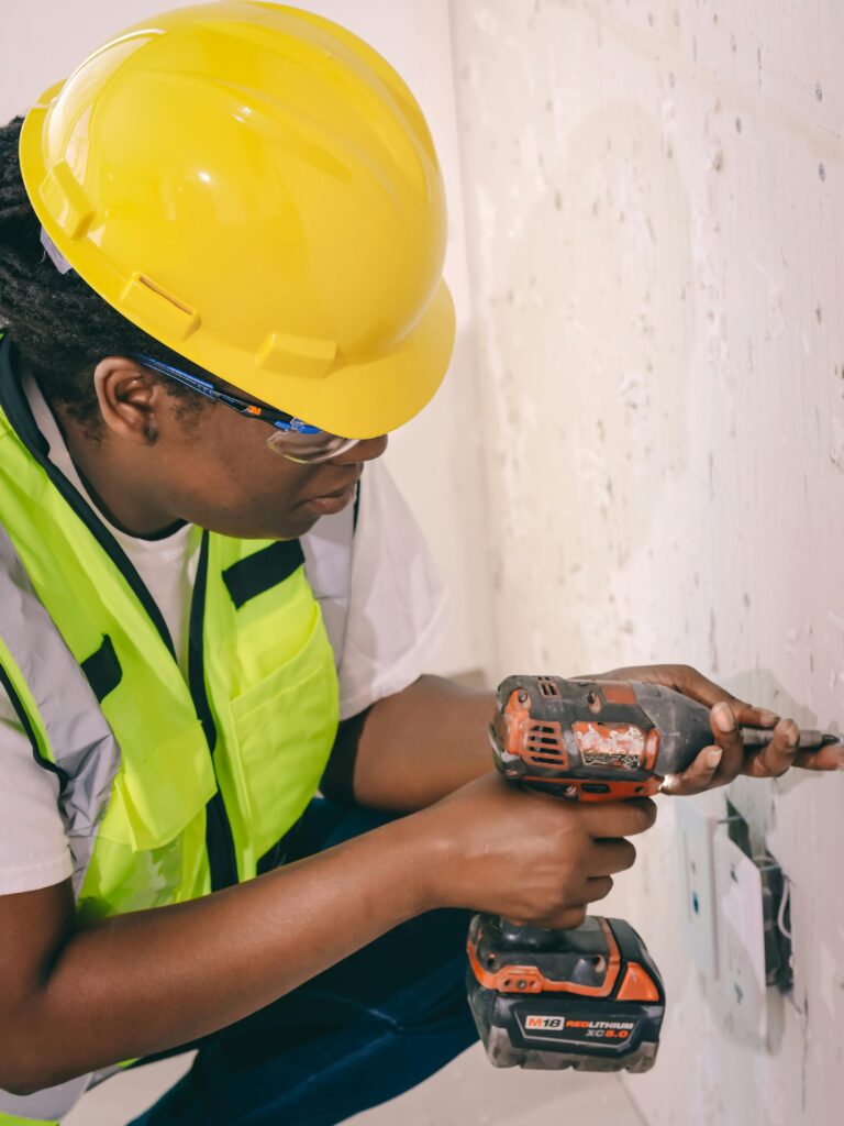 Handywoman Drilling the Wall